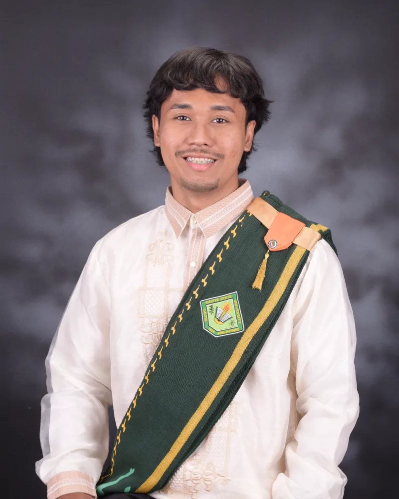 Eirmon John Paculan in a barong with his Cavite State University sash